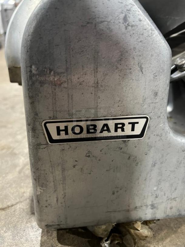 Hobart Commercial Electric Meat Slicer, Model 1612E. Features metal body, visible label. Suitable for 220/240V, 1 Phase.