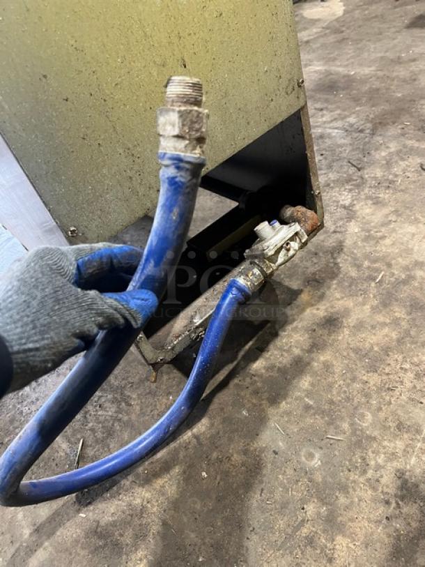 Asber commercial stainless steel natural gas fryer model AEF4050SENG with attached blue gas hose, showing interior connections.