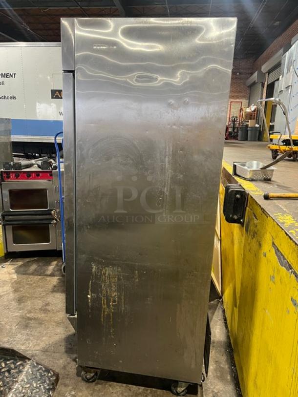 Arctic Air AF23 stainless steel single door reach-in freezer, visible wear, on casters, with poly coated wire rack.