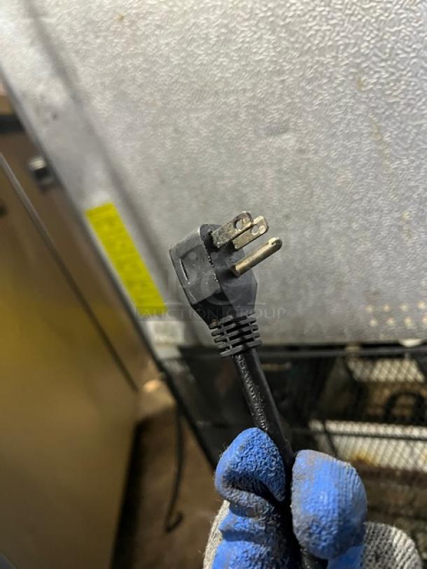 Arctic Air AF23 single door freezer plug detail, showing condition. 115V, stainless steel body, on casters. Poly coated rack inside.