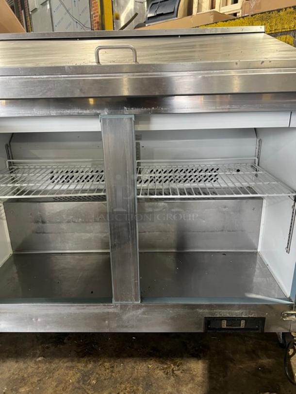 Maxx Cold stainless steel 2-door refrigerated prep table, model MXCR48MHC, with poly-coated wire rack, on casters.