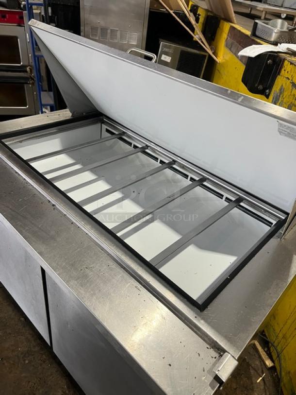 Maxx Cold stainless steel refrigerated prep table, model MXCR48MHC, with two doors, wired rack, on casters.