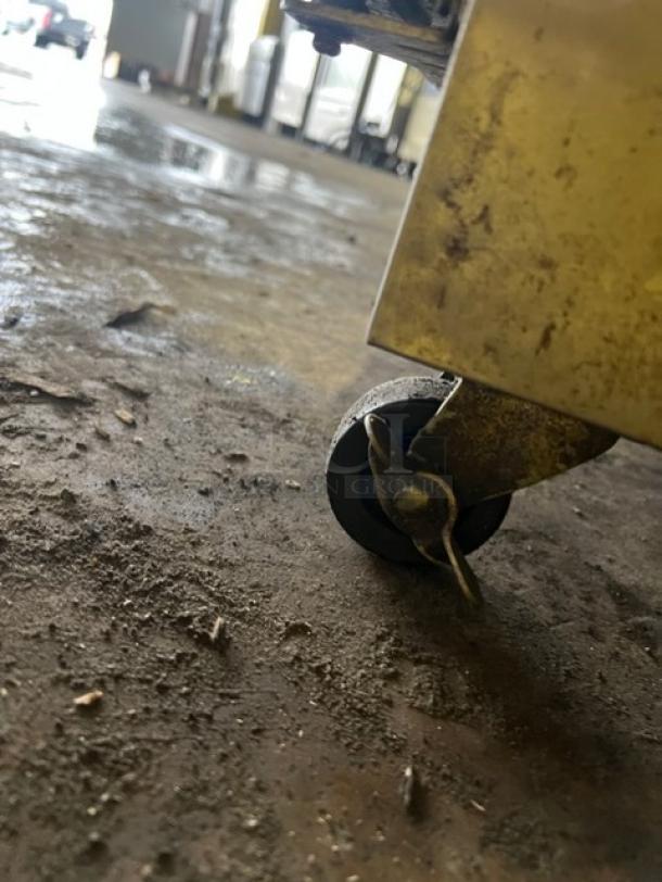 Maxx Cold prep table caster wheel, showing signs of use. Part of a Modelo MXCR48MHC refrigerated salad/sandwich unit.