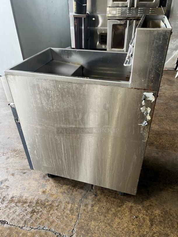 Asber AEF75NGGAS stainless steel deep fat fryer, natural gas, with back splash, basket hanger, and casters, visible wear.