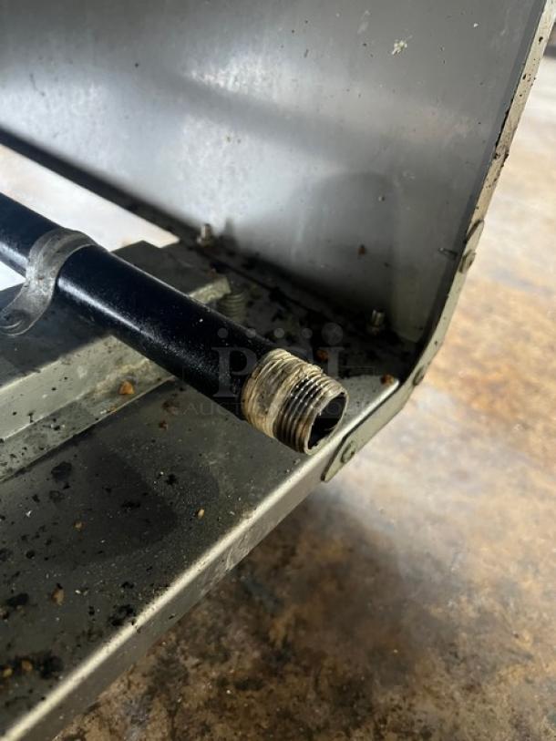 Asber stainless steel deep fat fryer model AEF75NGGAS, featuring a backsplash and basket hanger; on casters, showing gas connection.