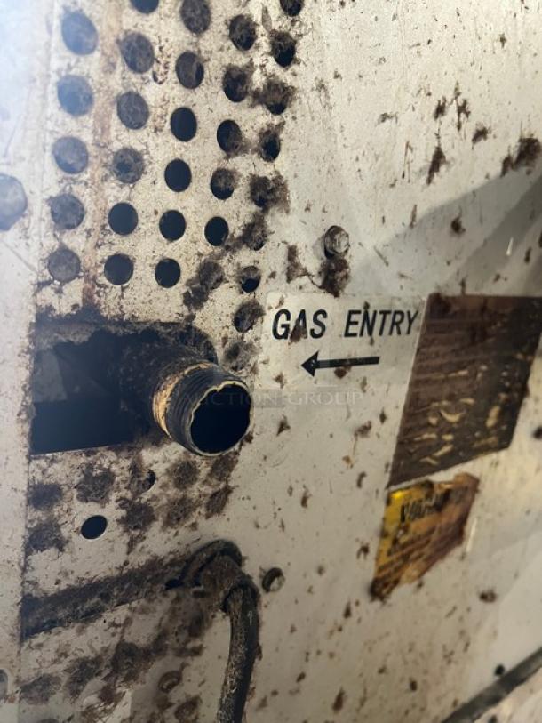 Patriot FMCOF54NG convection oven gas entry port, visible markings. Pre-owned, stainless steel, natural gas-powered.