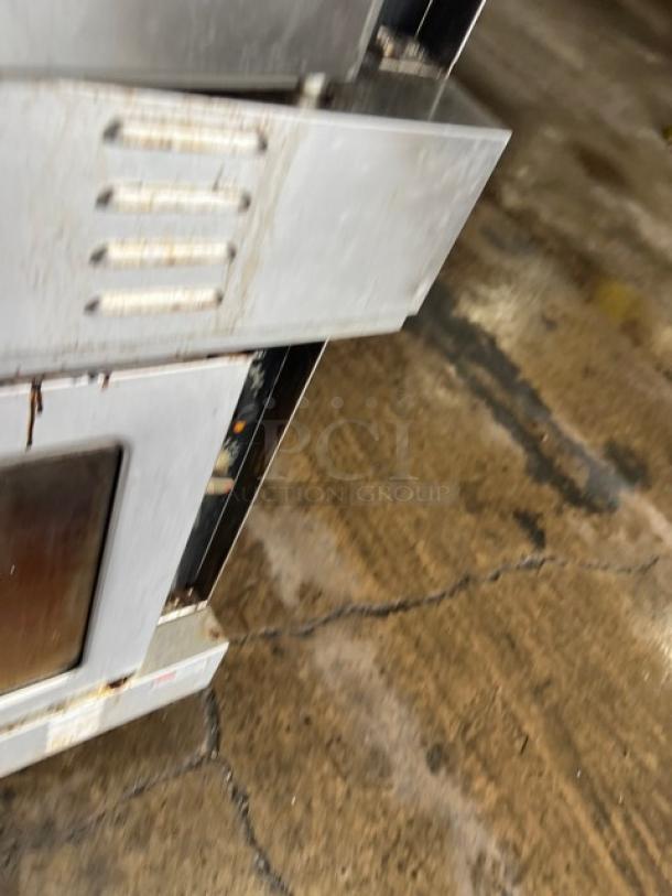 Patriot double stacked convection oven FMCOF54NG, stainless steel, natural gas, on casters, visible wear on exterior.