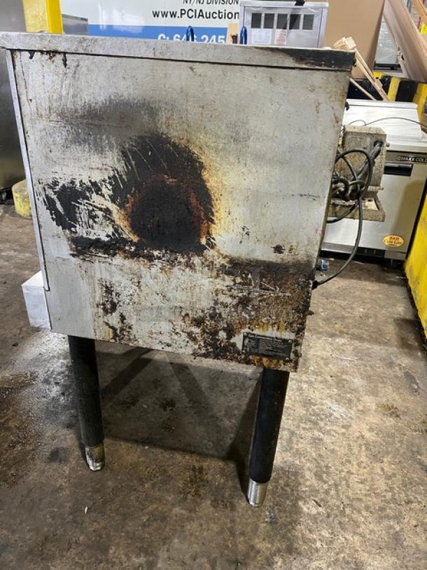 Cpg commercial stainless steel gas convection oven, single stack, with thermostatic controls, on legs, visible wear and rust.