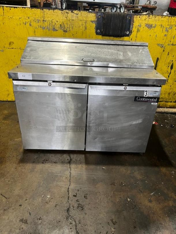 Continental Commercial Stainless Steel 2-Door Refrigerated Bain Marie Salad/Sandwich Prep Table, 115V, on legs, visible wear.
