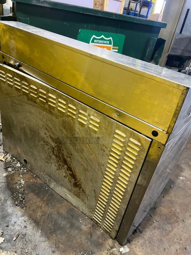 Continental 2-door stainless steel refrigerated bain marie prep table, 115V, worn condition, on legs, vented panels visible.