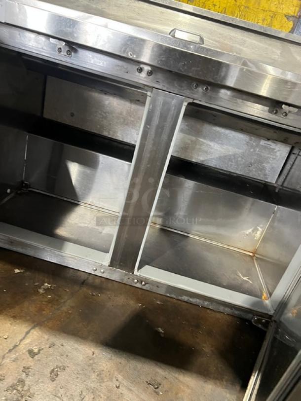 Continental stainless steel 2-door refrigerated prep table, Bain Marie style, on legs, 115V, open doors showing interior.