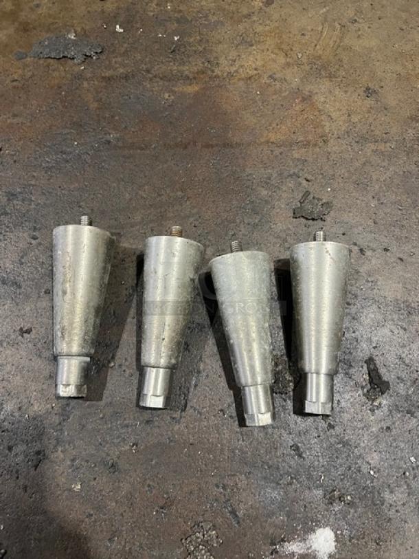 Four stainless steel table legs, slightly worn, suitable for Continental commercial prep tables.
