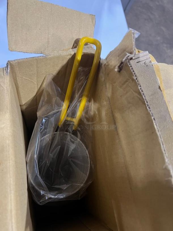 New Connoisseur commercial round pasta basket with yellow-coated handle in packaging, ideal for high-volume cooking.