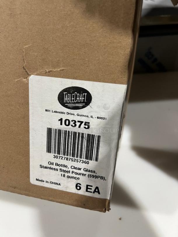 New TableCraft Model 10375 clear glass oil & vinegar cruet bottle, 18 oz., with stainless steel pourer. Box label visible.