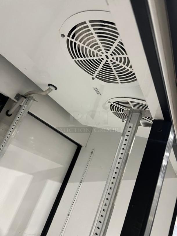 True GDM-49RL double glass swing door merchandiser refrigerator, black and white, poly-coated wire rack, 115V, 1 phase.