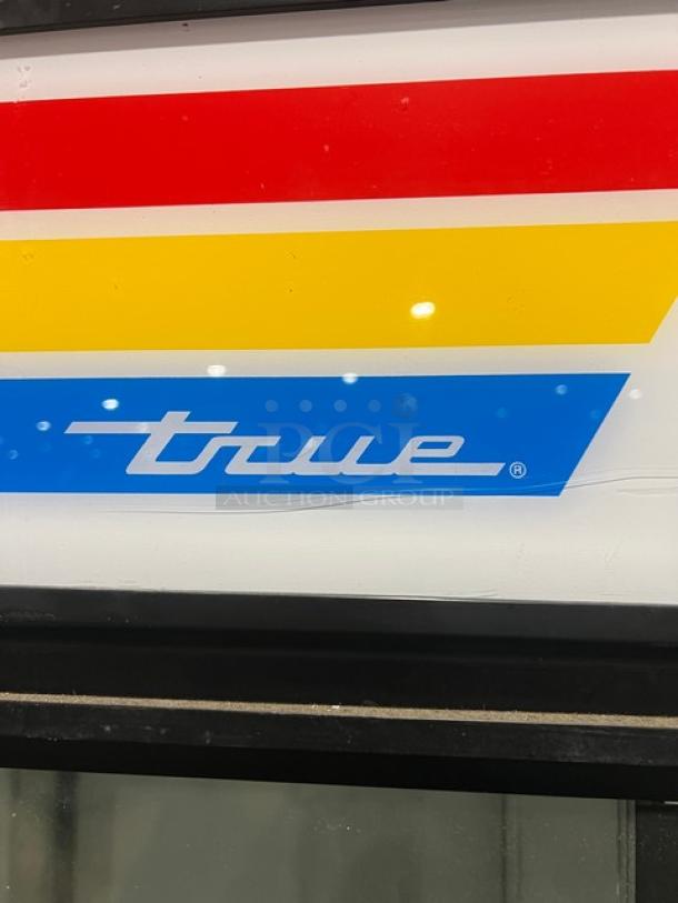 True GDM-49RL commercial double glass door merchandiser refrigerator, features poly coated wire racks, visible brand logo.