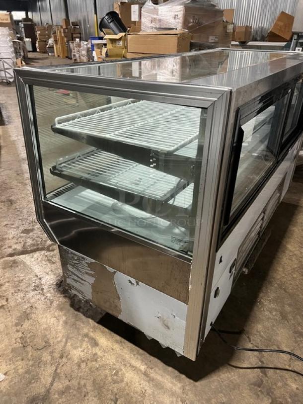Leader NCBK77 stainless steel display case, two-tier, straight glass, rear sliding doors, poly coated racks, used condition.