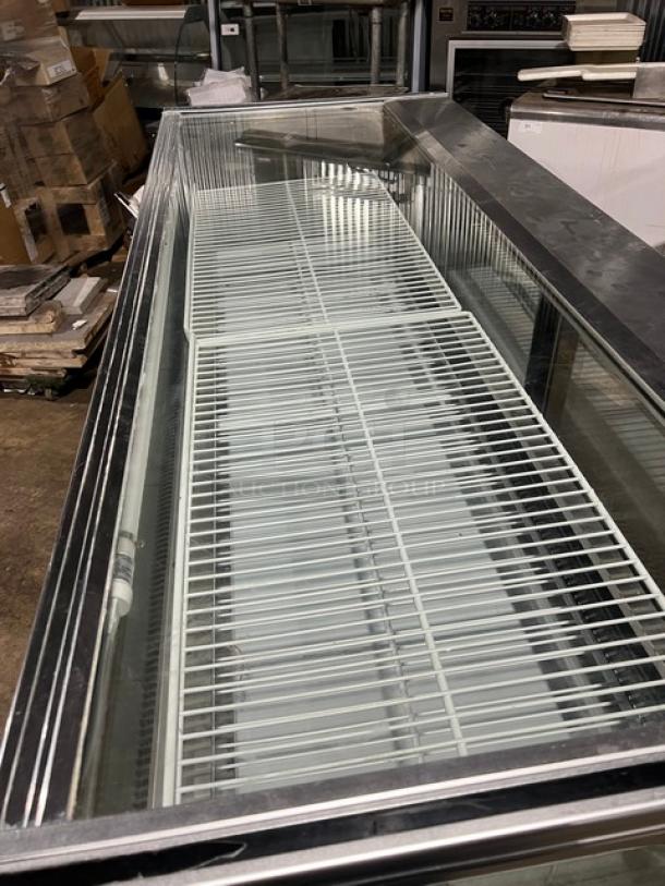 Leader NCBK77 stainless steel bakery display case with straight glass, poly-coated wire rack, and rear sliding glass doors.