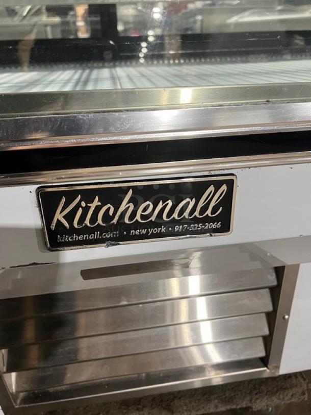 Leader NCBK77 stainless steel bakery display case with straight glass, two-tier poly coated rack, rear glass sliding doors.