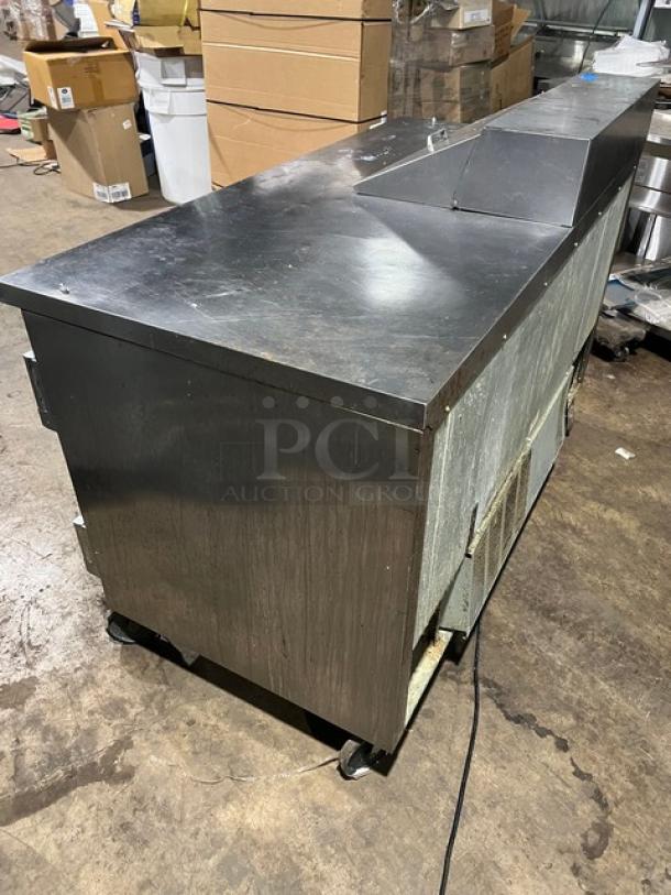 Beverage-Air SPE60-08 refrigerated prep table, stainless steel, two doors, on casters, with poly-coated wired rack.