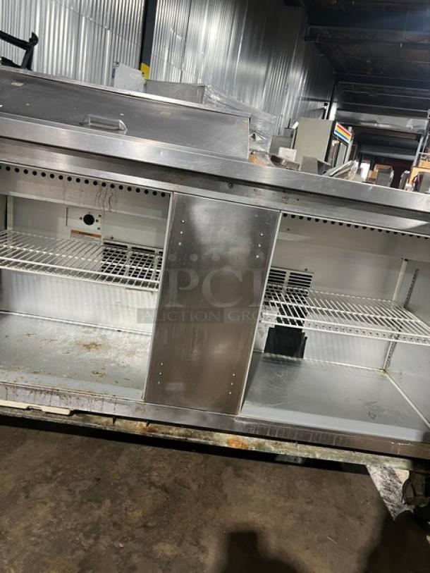 Beverage-Air SPE60-08 stainless steel refrigerated prep table, 2-door, poly-coated racks, on casters, commercial kitchen use.
