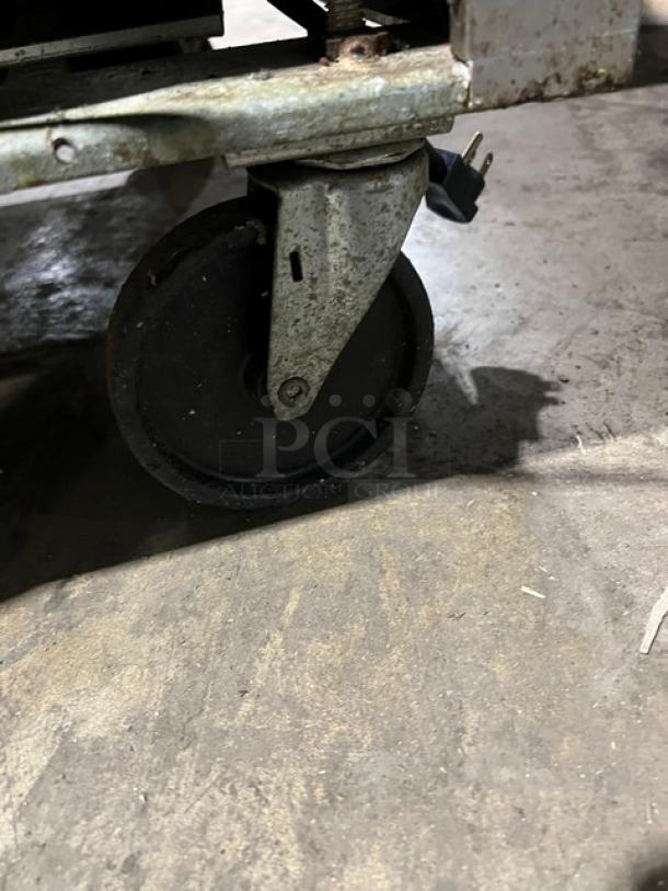 Beverage-Air SPE6008 prep table caster. Shows condition and mobility feature on concrete floor.