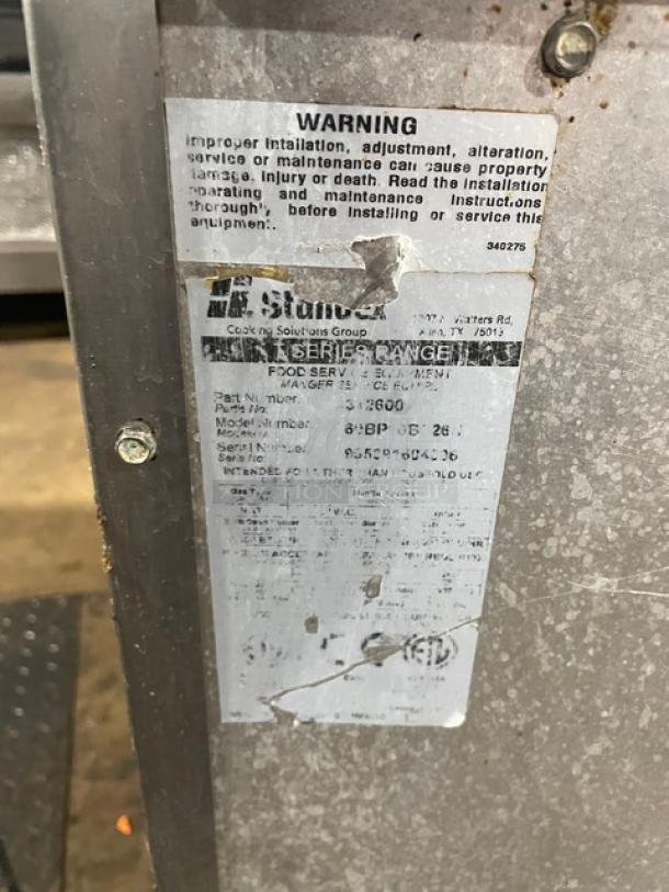 American Range label detailing model number 2600, with safety warning about installation, adjustment, and maintenance.