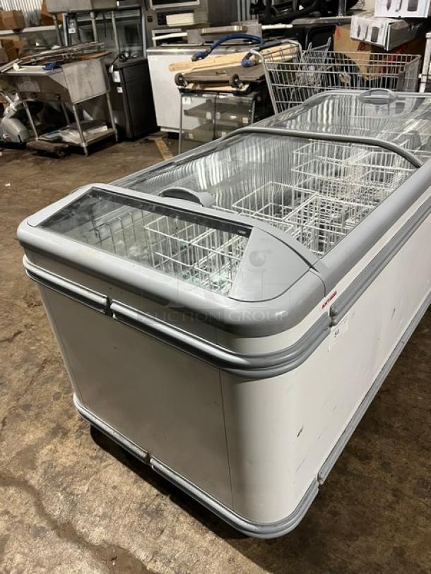 AHT MALTA 185 heavy-duty commercial chest freezer with double sliding glass doors, 120V 1 Phase. Model and serial labels visible.