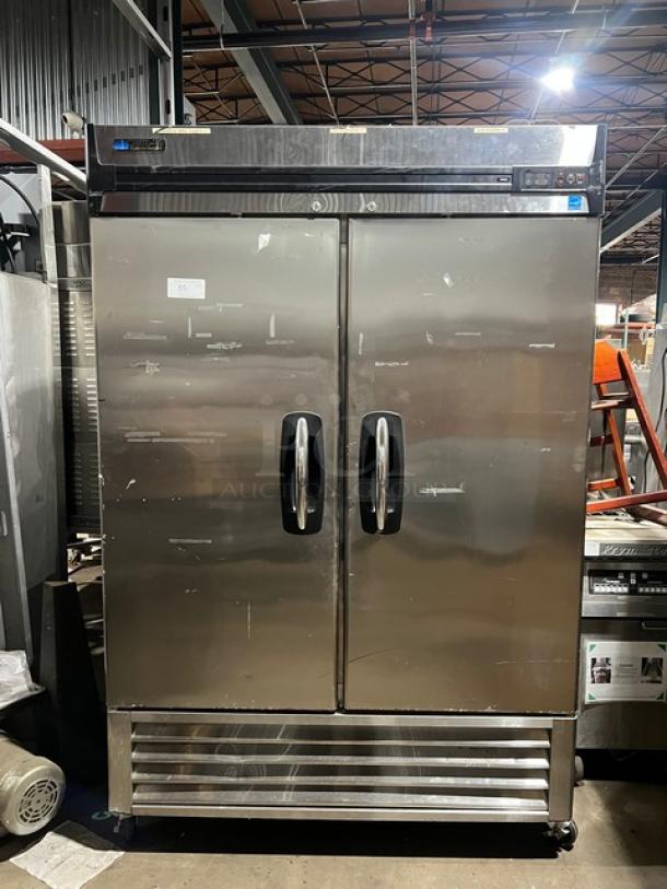 Masterbilt Fusion Series F49S stainless steel 2-door reach-in freezer with poly-coated racks, on commercial casters. Model F49S, Serial 14110103, 115V 1 Phase. Visible wear, labels, and control panel on top.
