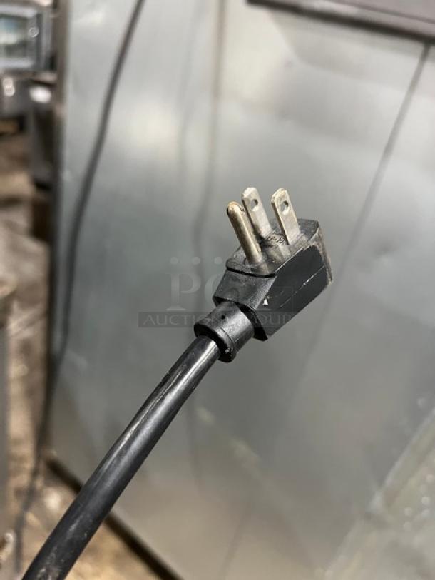 Three-prong power plug from a Turbo Air M3F47-2 reach-in freezer, indicating a 115V, 1-phase connection.