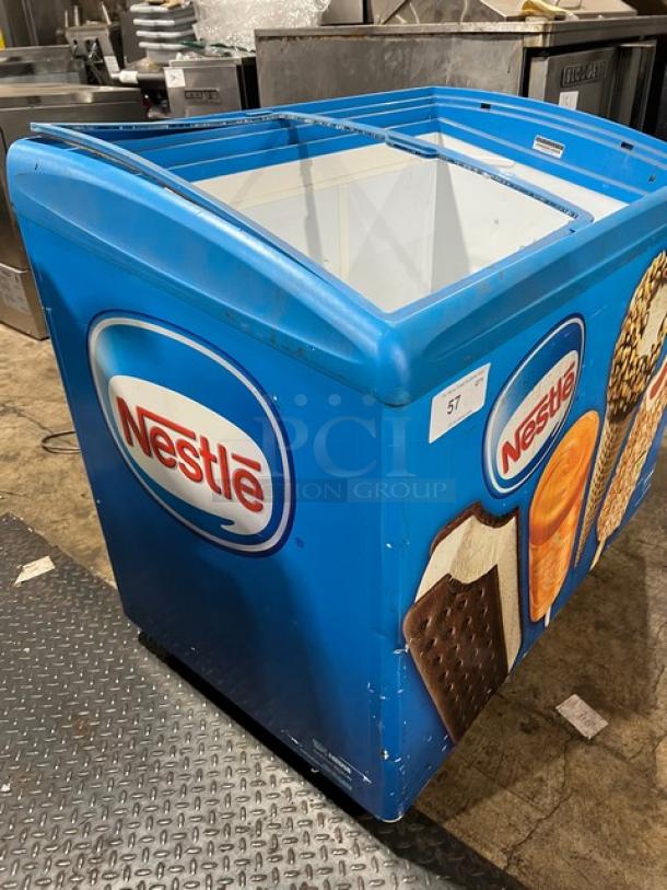 AHT RIO S100 Reach Down Freezer Merchandiser, blue with Nestle branding, 120V 1 Phase, serial 60060100000925, good condition.