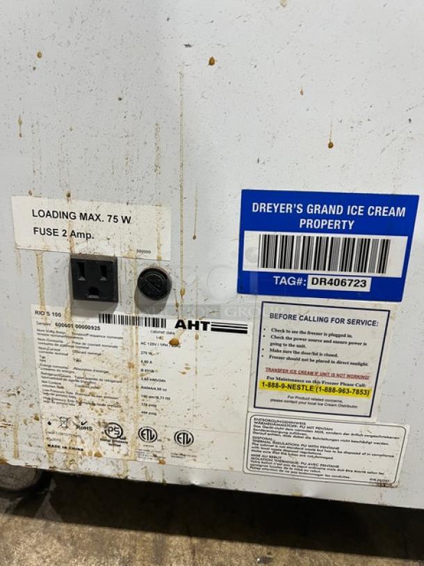 AHT Reach Down Freezer Merchandiser, Model RIO S 100, Serial 60060100000925, 120V 1 Phase, with service and brand tags.