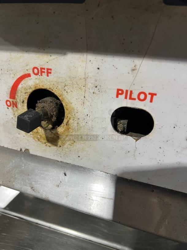 CPG 15" natural gas char broiler grill, countertop model, with legs. Visible on/off and pilot controls, signs of use.