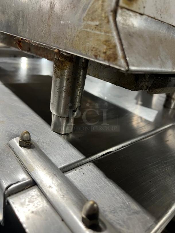 CPG 15" natural gas countertop char broiler grill, stainless steel, on legs, showing some wear and usage marks.