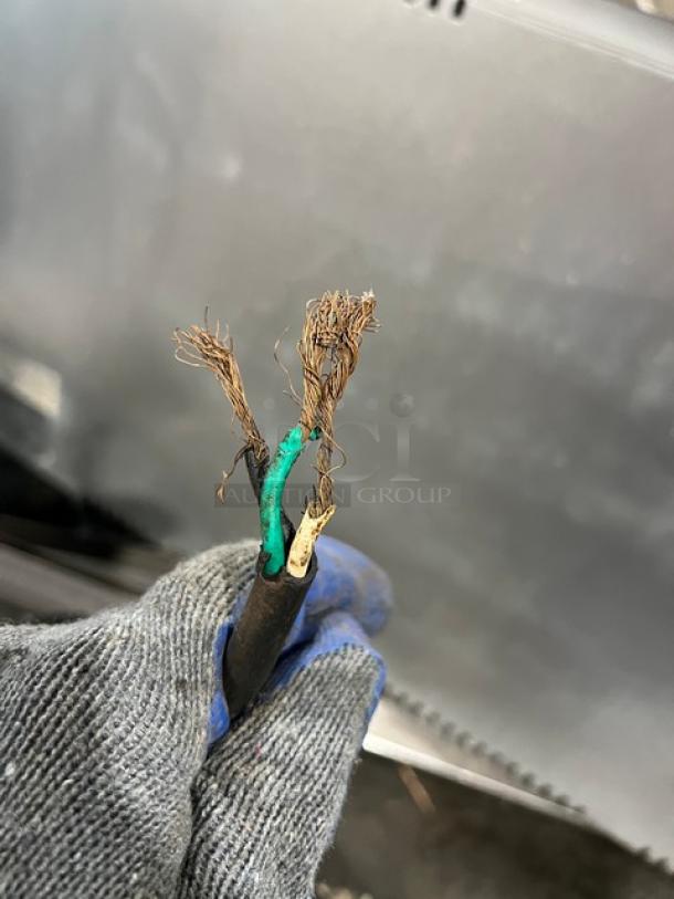 Frayed power cord of Moffat Turbo Fan Convection Oven, Model E25. Damage indicates electrical repair needed.