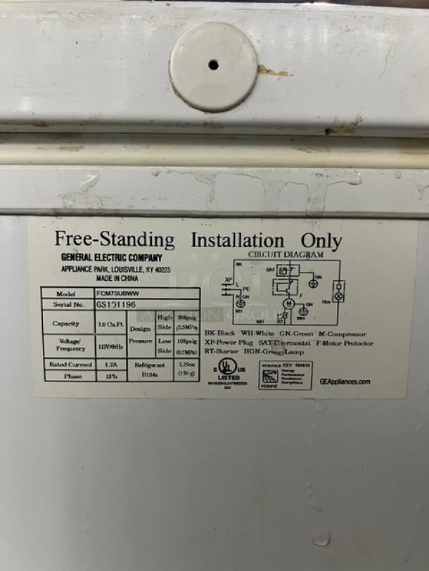 GE White Deep Chest Freezer, Model FCM7SUBWW, Serial GS101196. Voltage: 115V, 1 Phase. Free-standing installation only.