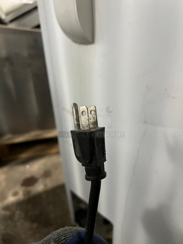 GE white deep chest freezer, model FCM7SUBWW. Features 115V, 1 phase. Serial GS101196. Power cord shown. Good condition.