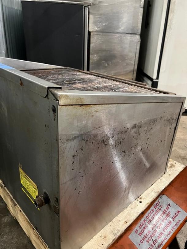 MagicKitchn 36" natural gas countertop char broiler grill with cheese melter, showing signs of use, includes visible safety labels.
