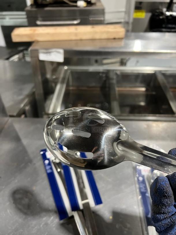 Brand new Winco Prime BSON-21 stainless steel slotted basting spoon, shiny finish, 21-inch length.