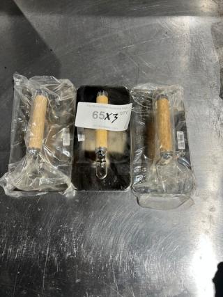 Brand new Vollrath stainless steel weights with wooden handles. Includes labels indicating 3x quantity.