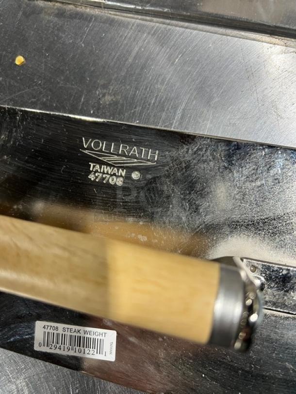 Vollrath stainless steel steak weight, brand new, marked "Vollrath Taiwan 47708." Wood handle, visible barcode label.