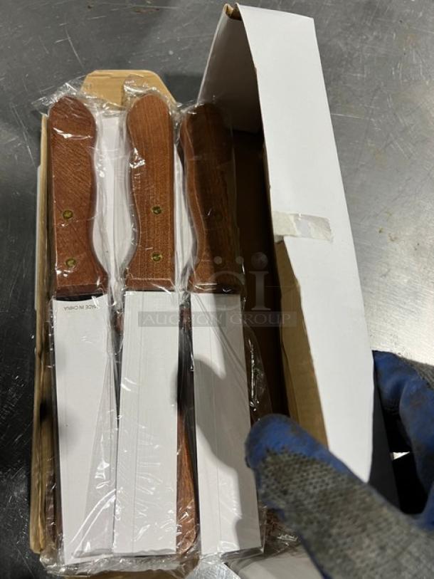 New in box Walco heavy-duty steak knives, set of 12. Knives have wooden handles and stainless steel blades, factory-sealed.