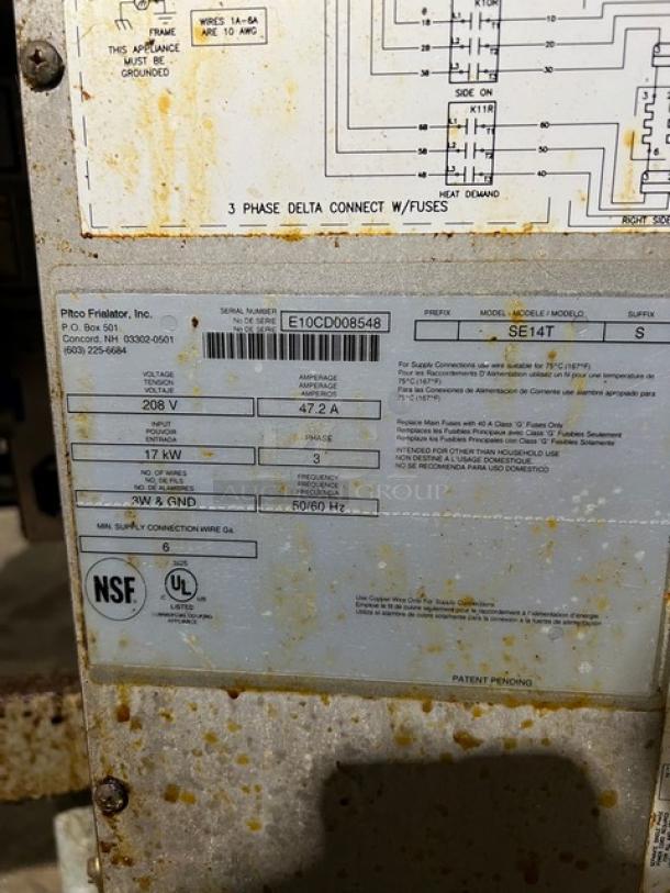 Pitco Soltice SE14T split tank electric deep fryer, model SE14T, serial E10CD008548, on legs with individual controls.