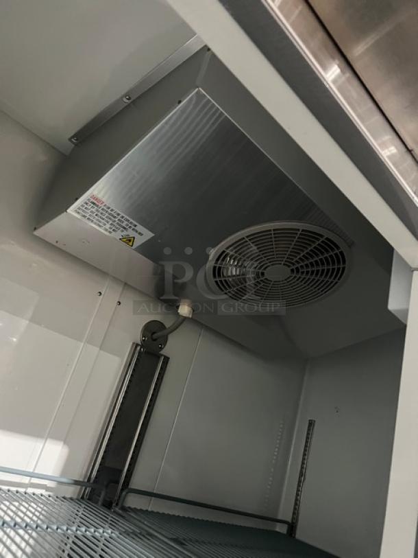 Avantco 2 Door Stainless Steel Reach-In Freezer, Model 178A49FHC, interior view showing shelving and cooling fan.