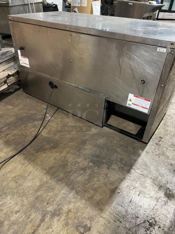 True TUC60 stainless steel refrigerated work top lowboy cooler, 115V, 1 phase, serial 10343969, on casters, used condition.