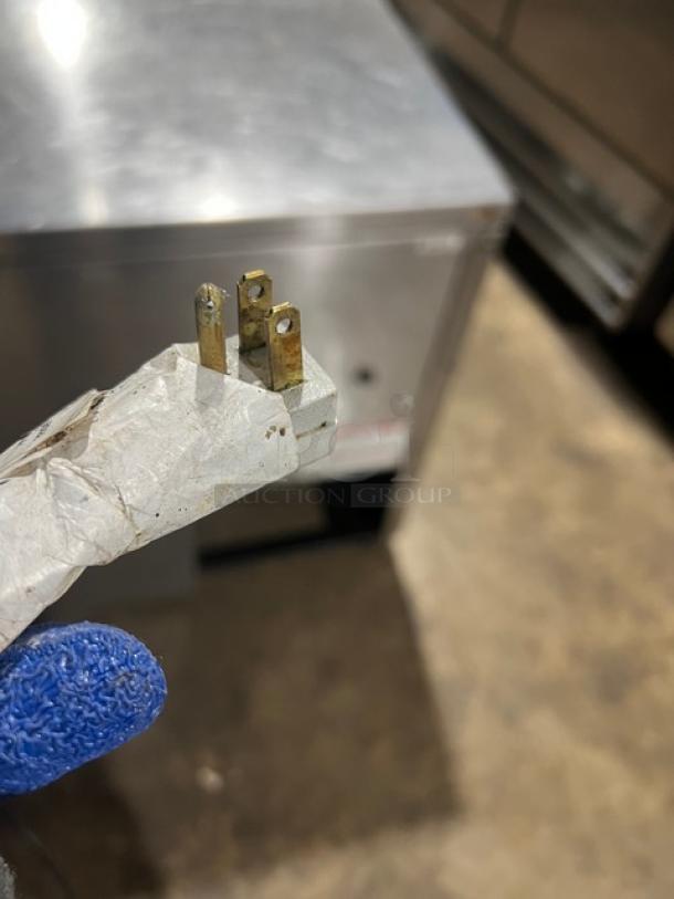 True TUC60 stainless steel cooler, serial 10343969. Features include a 115V plug and casters. Good condition.