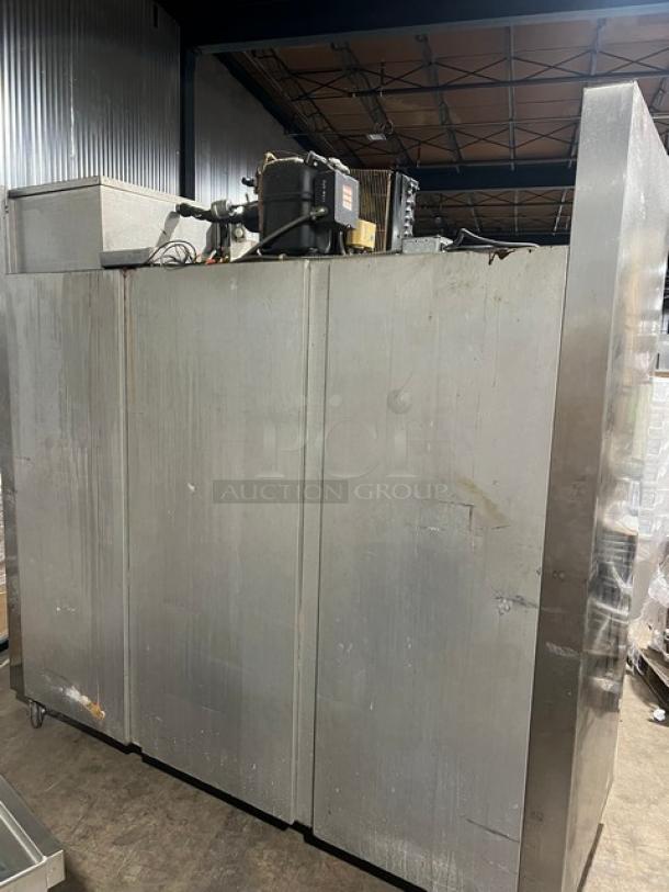 Traulsen 6 Split Door Reach In Cooler with built-in pan racks, on casters, 115V 1 Phase. Visible wear.