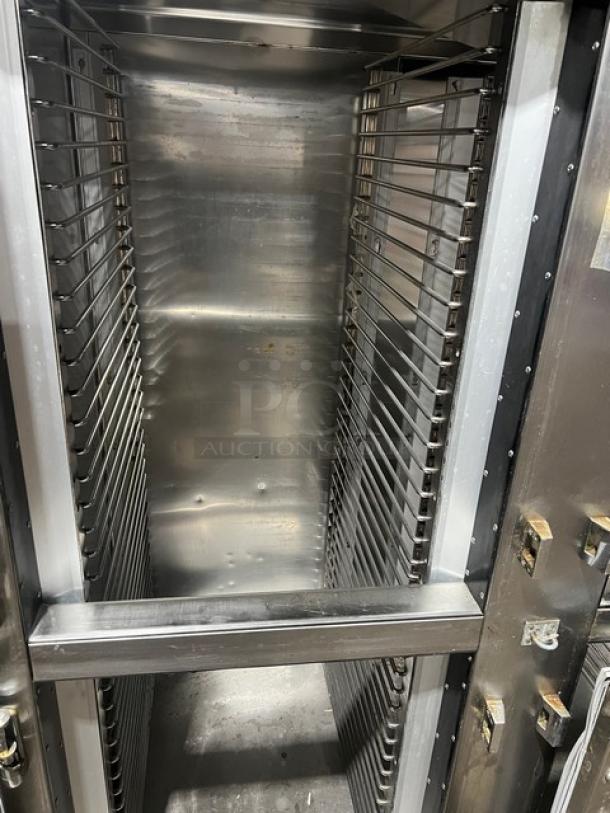 Traulsen 6 split door reach-in cooler with built-in pan racks on casters. Stainless steel interior, 115V, 1 phase.