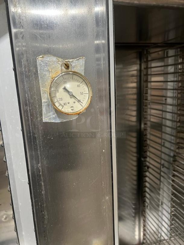 Traulsen 6 split door reach-in cooler on casters, featuring built-in pan racks and external thermometer. 115V, 1 phase.