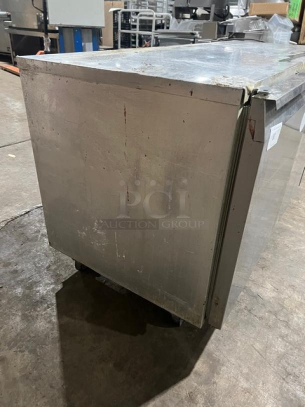 Continental 3 Door Under Counter Lowboy Cooler with racks, on casters. Visible wear and scratches. Model for 115V 1Phase.
